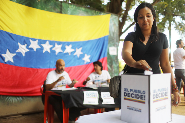 A Venezuelan woman votes in a symbolic referendum.