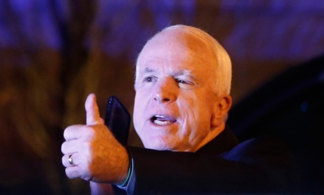Sen. John McCain gives a thumbs up as he emerges from a private dinner with President Obama on March 6.