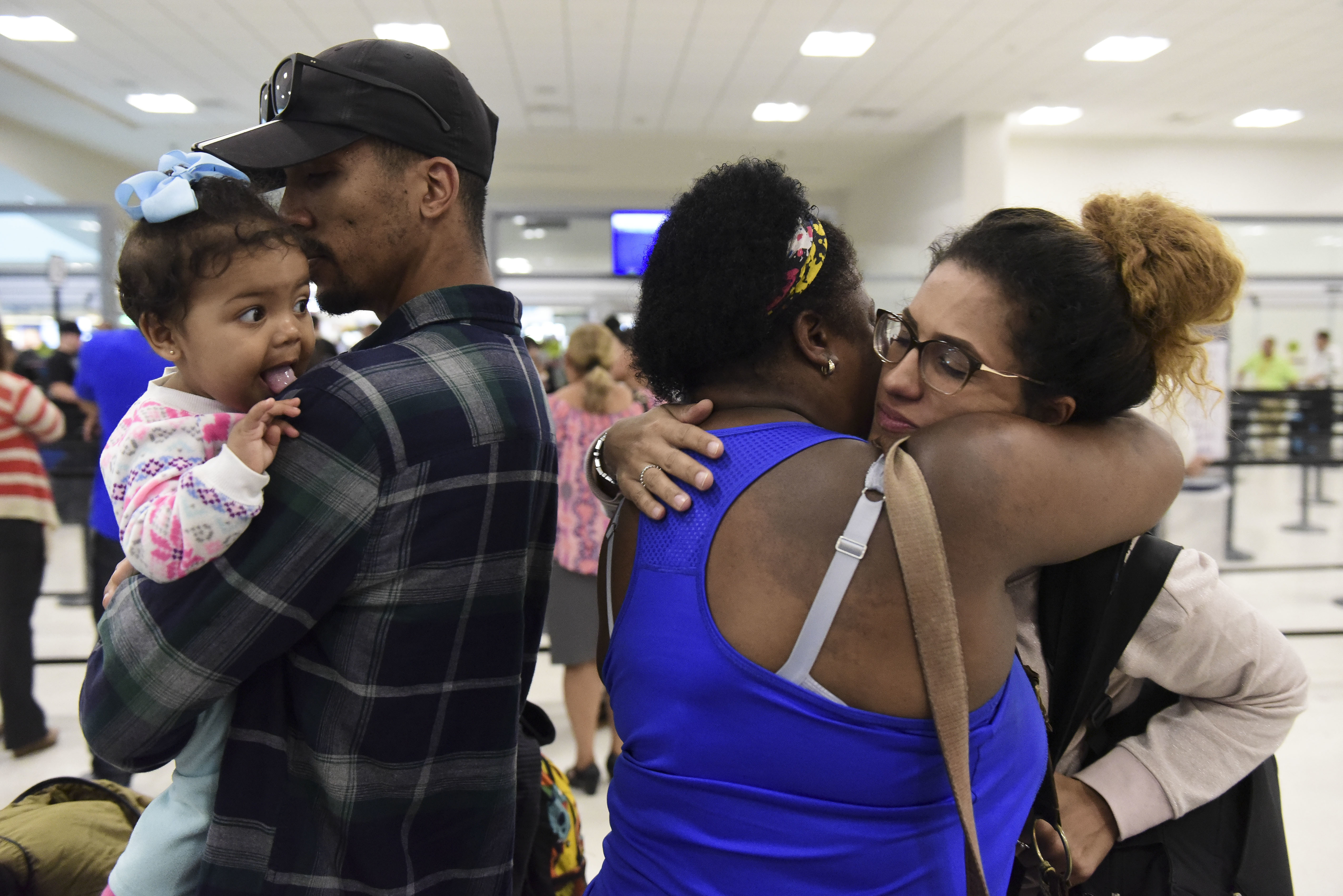 Victims of Hurricane Maria board a flight for Florida.