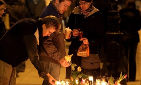 Mourners light candles in memory of President Lech Kaczynski.