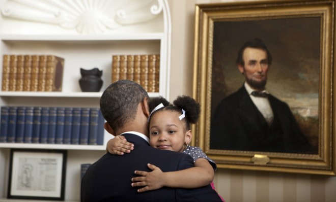 Three-year-old, Arianna Holmes wraps her tiny arms around the POTUS in the Oval Office, on Feb. 1, 2012.