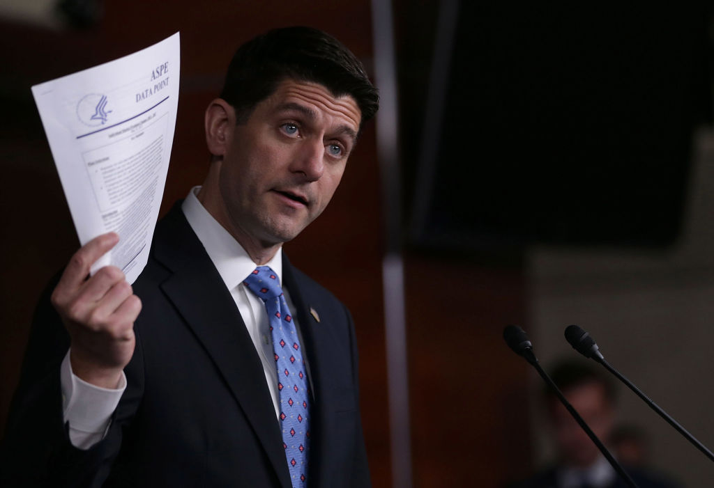 House Speaker Paul Ryan holds up a printout