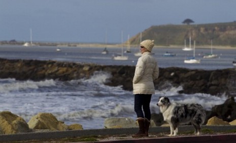 A San Francisco woman watches as waves hit the Pacific coast Friday: California didn&#039;t incur major damages from Japan&#039;s earthquake and tsunami... yet.