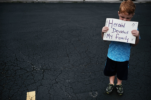 An Ohio child holds a heartbreaking sign.