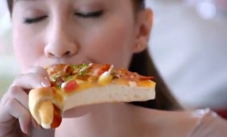 Moments before being proposed to, this woman in a Pizza Hut Malaysia ad takes an indulgent bite of her squirting crust pie.