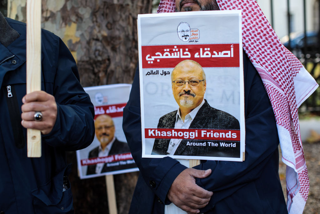 Protesters holding placards demonstrate against the killing of journalist Jamal Khashoggi outside the Saudi Arabian Embassy in London on October 26, 2018