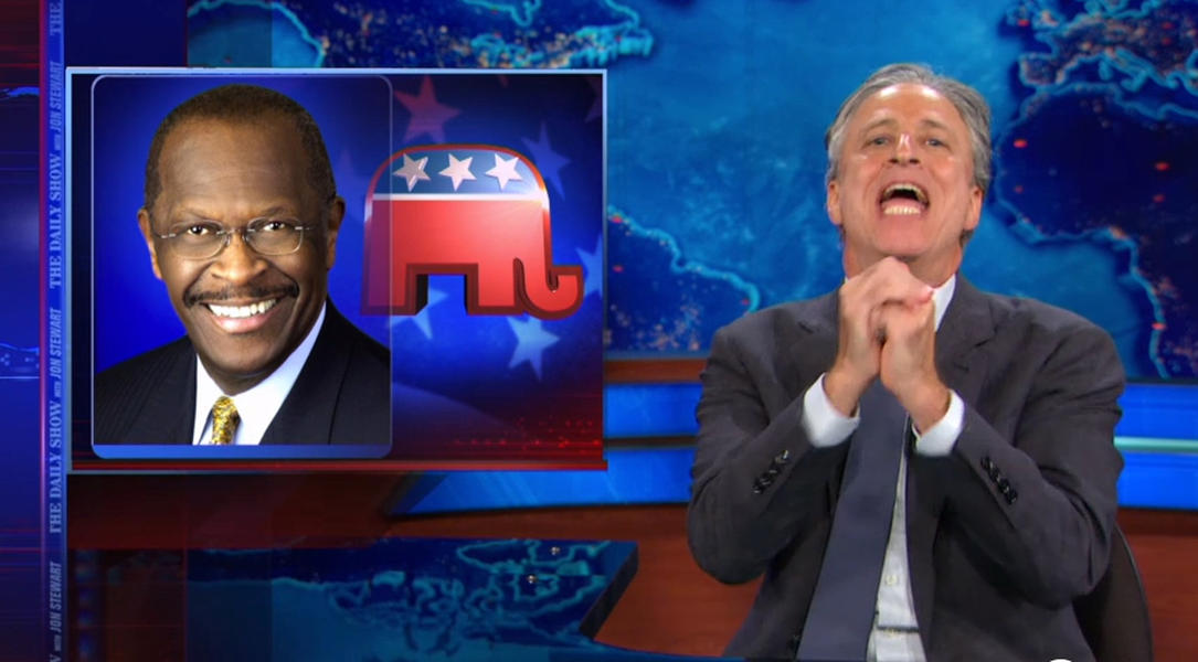 Jon Stewart literally prays for Herman Cain to run for president