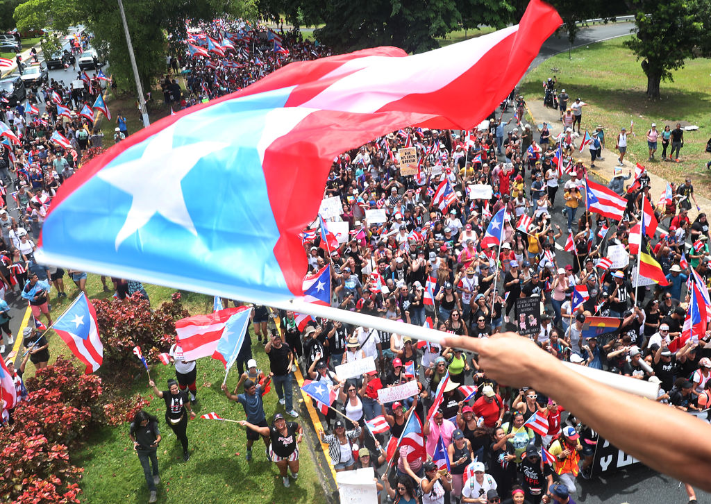 Puerto Ricans celebrate the resignation of their governor.