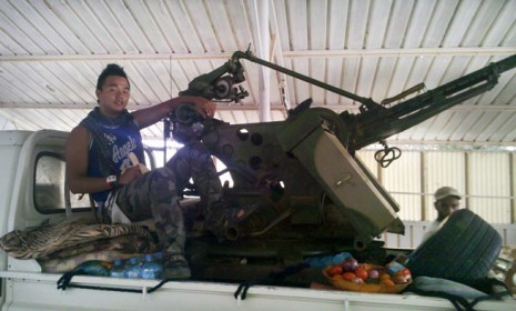 Chris Jeon is pictured manning an anti-aircraft weapon in Ras Lanuf, Libya.