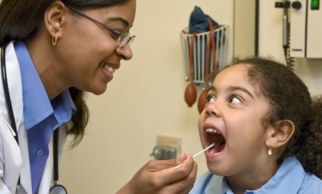 A child gets a strep test from a pediatrician