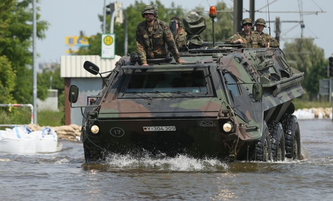 German soldiers ride an amphibious transporter through floodwaters from the swollen Elbe river on June 9 in Magdeburg.
