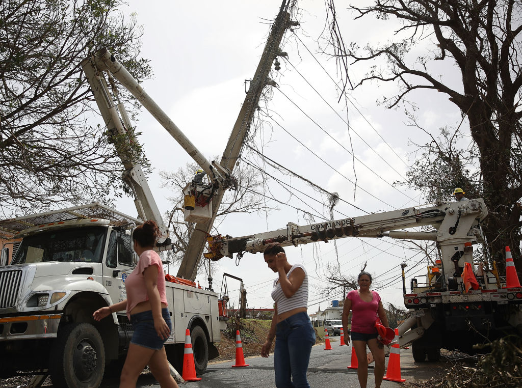 Workers repair a power line in Puerto Rico