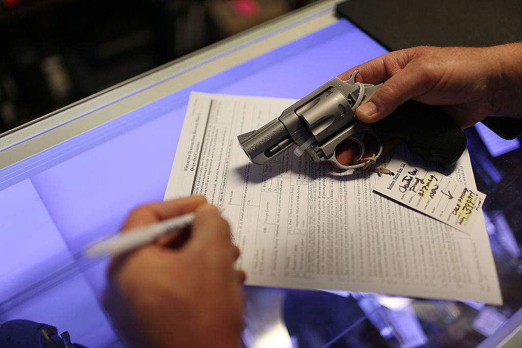 A man fills out paperwork for gun.