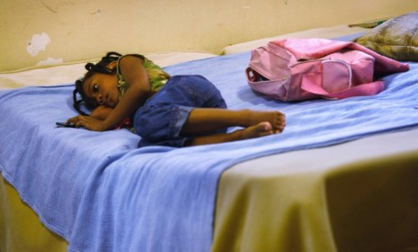 Cassandra Martin, age 6, lies on a bed in a Texas shelter in 2009: The recession has made 2011 the worst year for child homelessness.