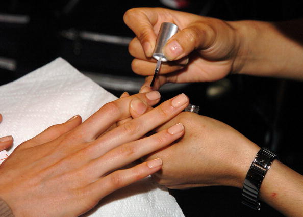 A woman receives a manicure