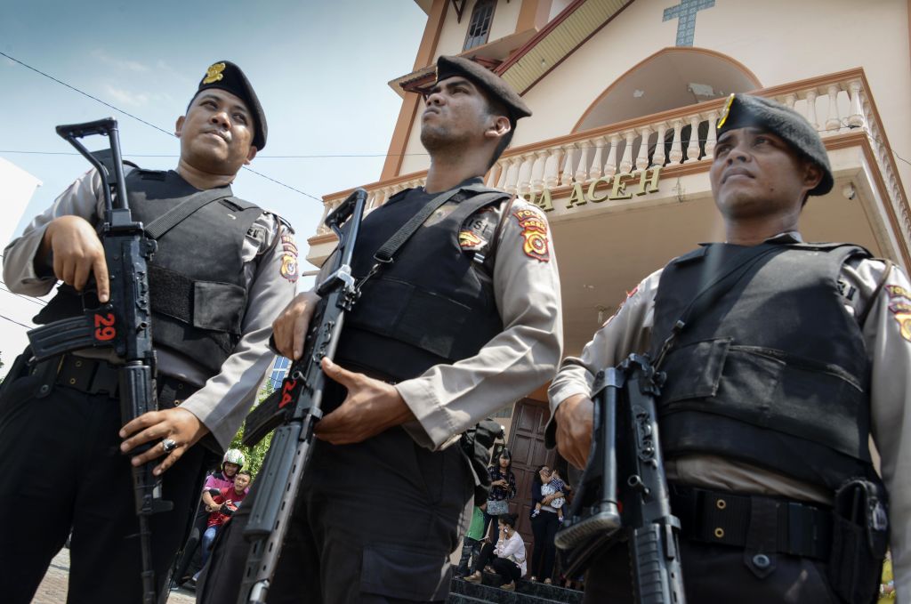 Police stand guard outside a church in Banda Aceh on May 13, 2018 following attacks on churches in Surabaya, Indonesia.