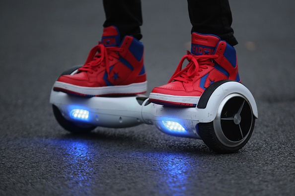 A teenager on a hoverboard.