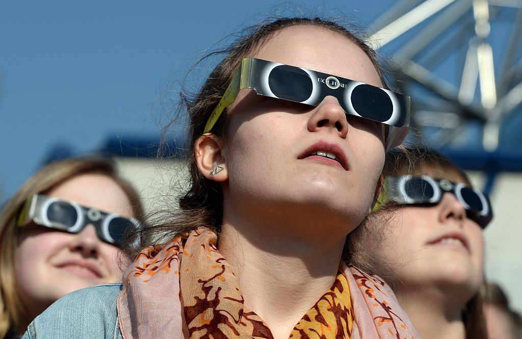 Girls wearing eclipse glasses.