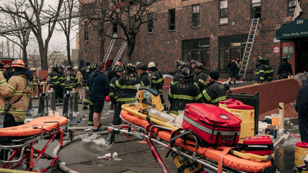 Firefighters at the scene of an apartment fire in the Bronx on Sunday.