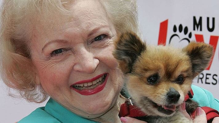 Betty White holds an adorable puppy.