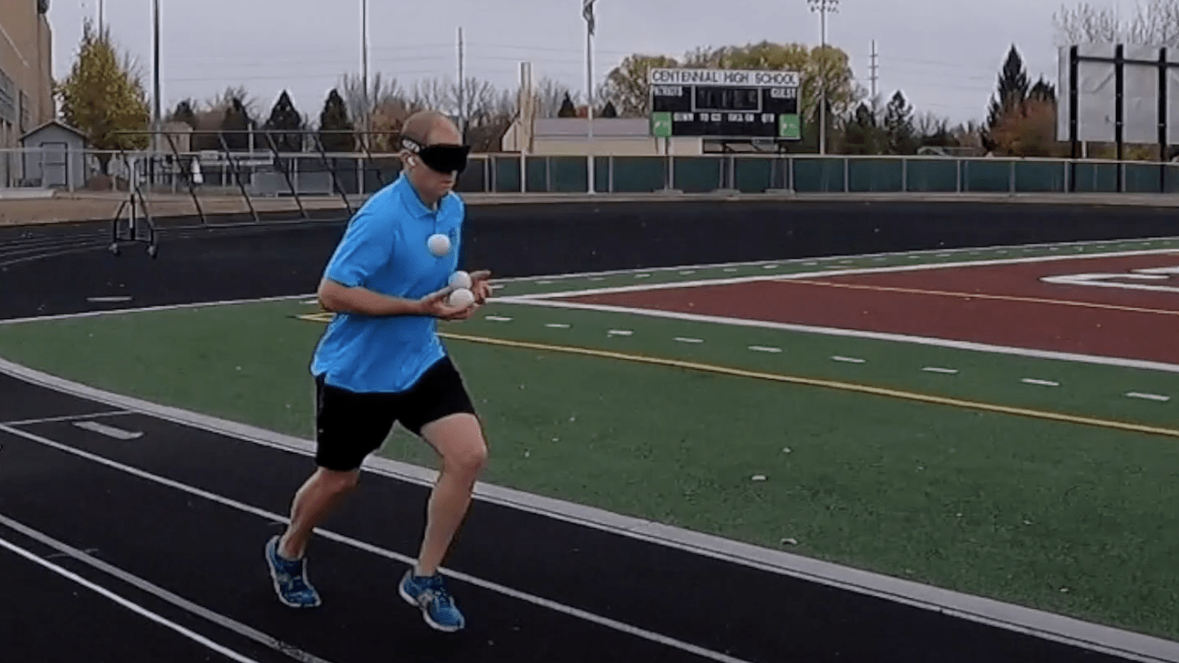 David Rush juggles while running blindfolded.