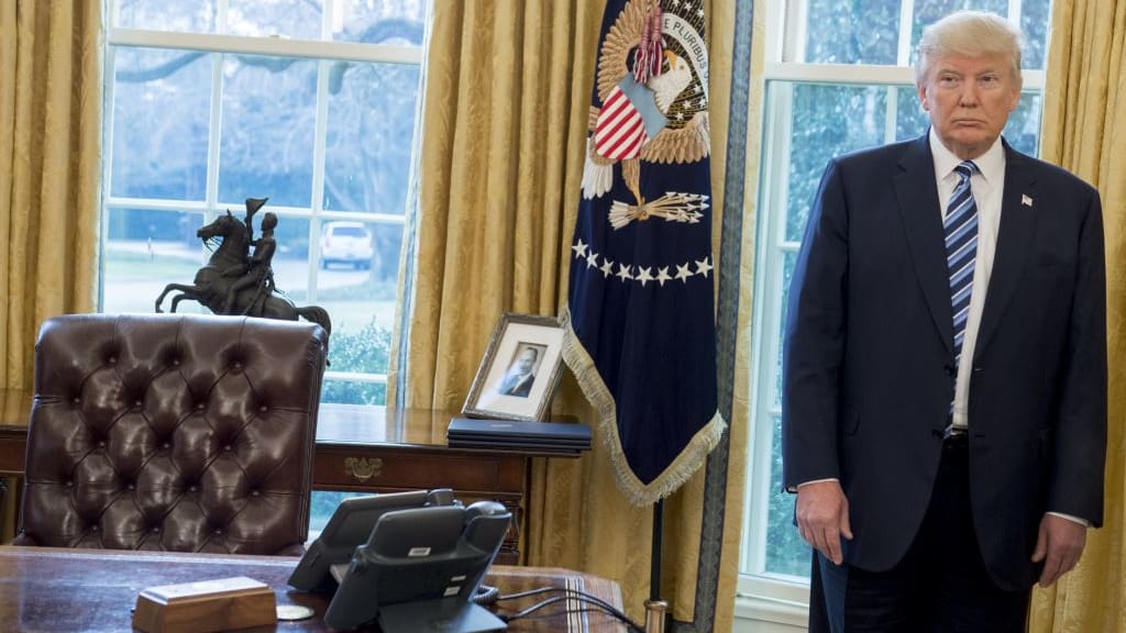 Donald Trump stands in the Oval Office.