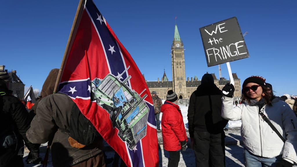 A protester carries a Confederate flag at an anti-mandate rally in Ottawa.