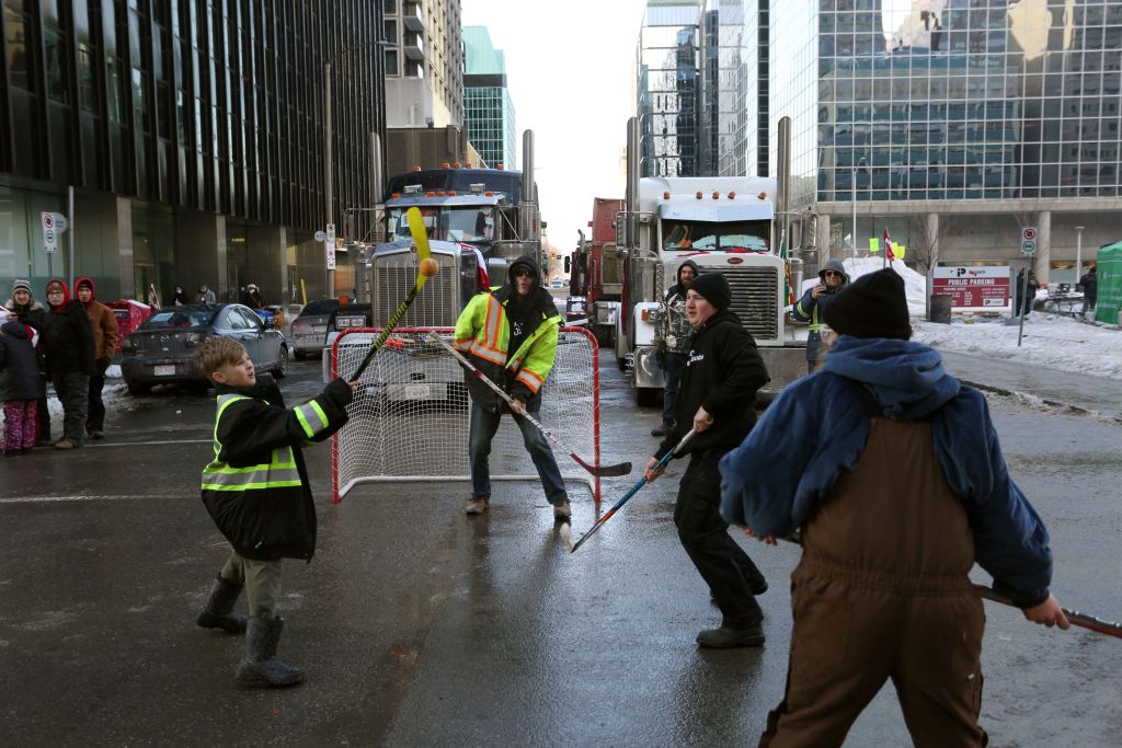 Child playing hockey at the trucker protest in Ottawa