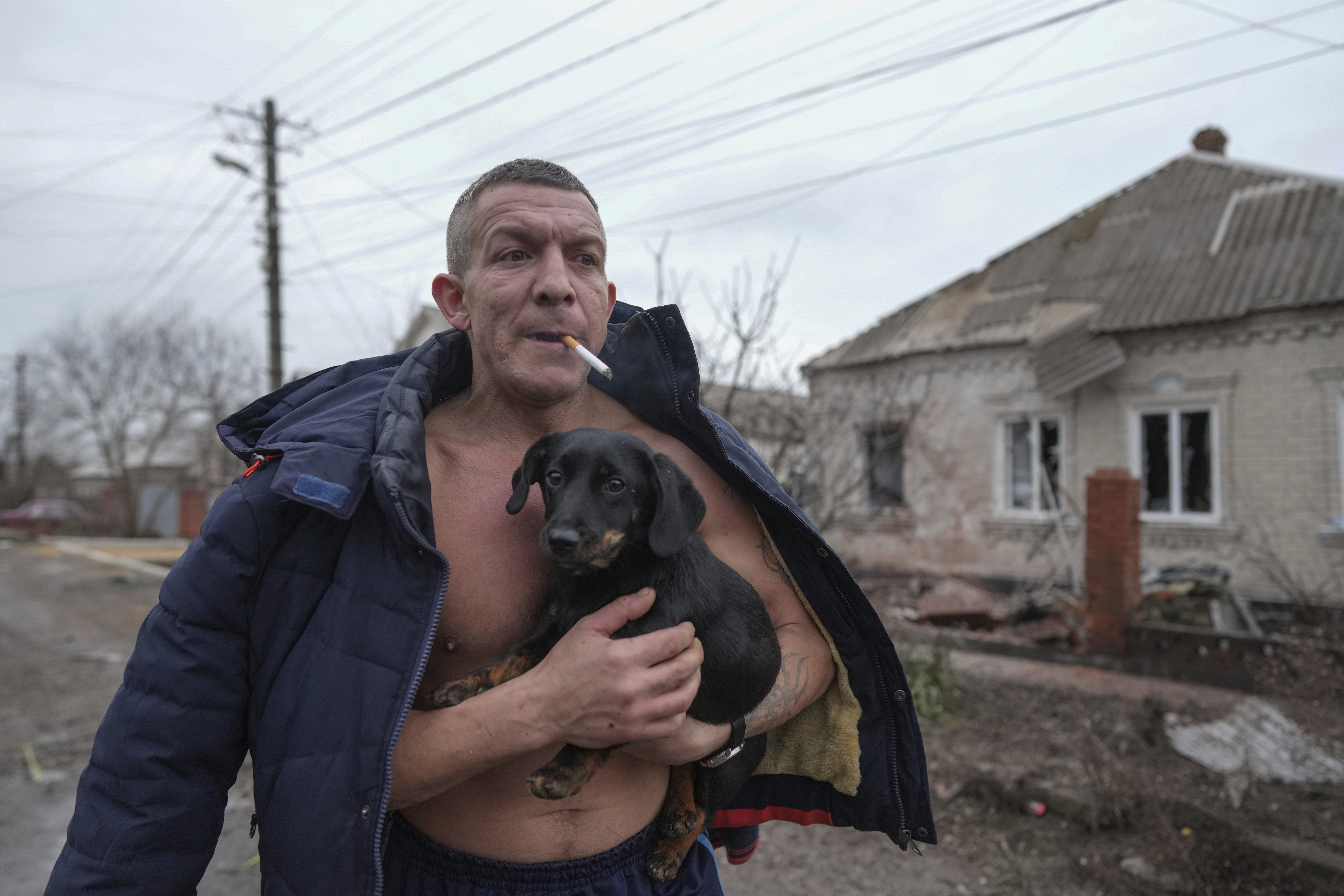 A man holding a dog.