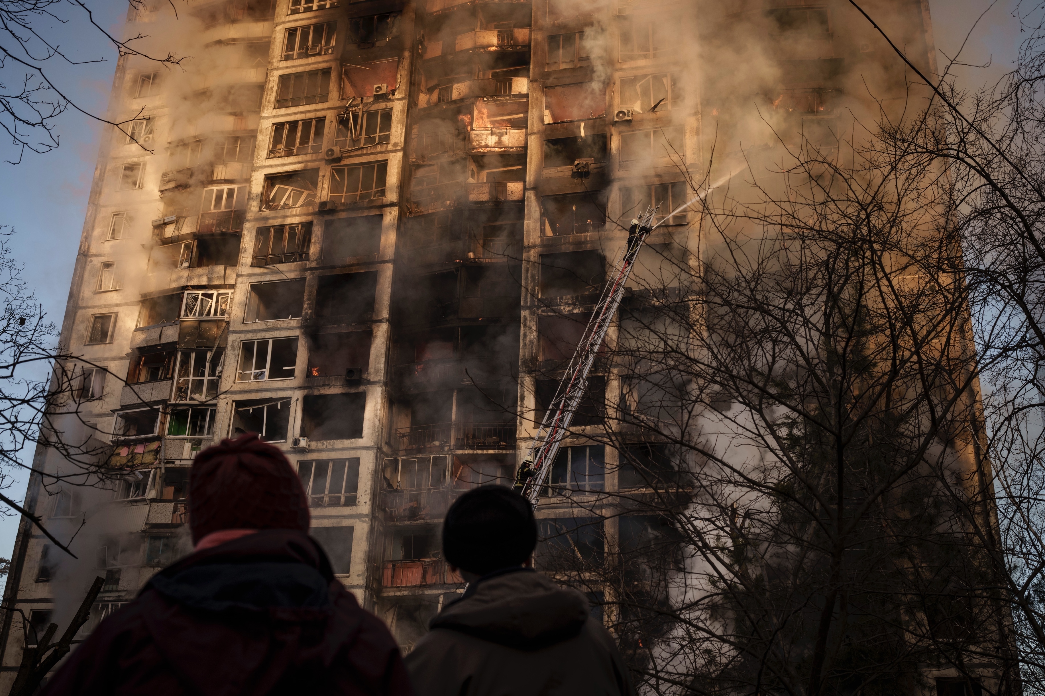 A bombed apartment building burns in Kyiv
