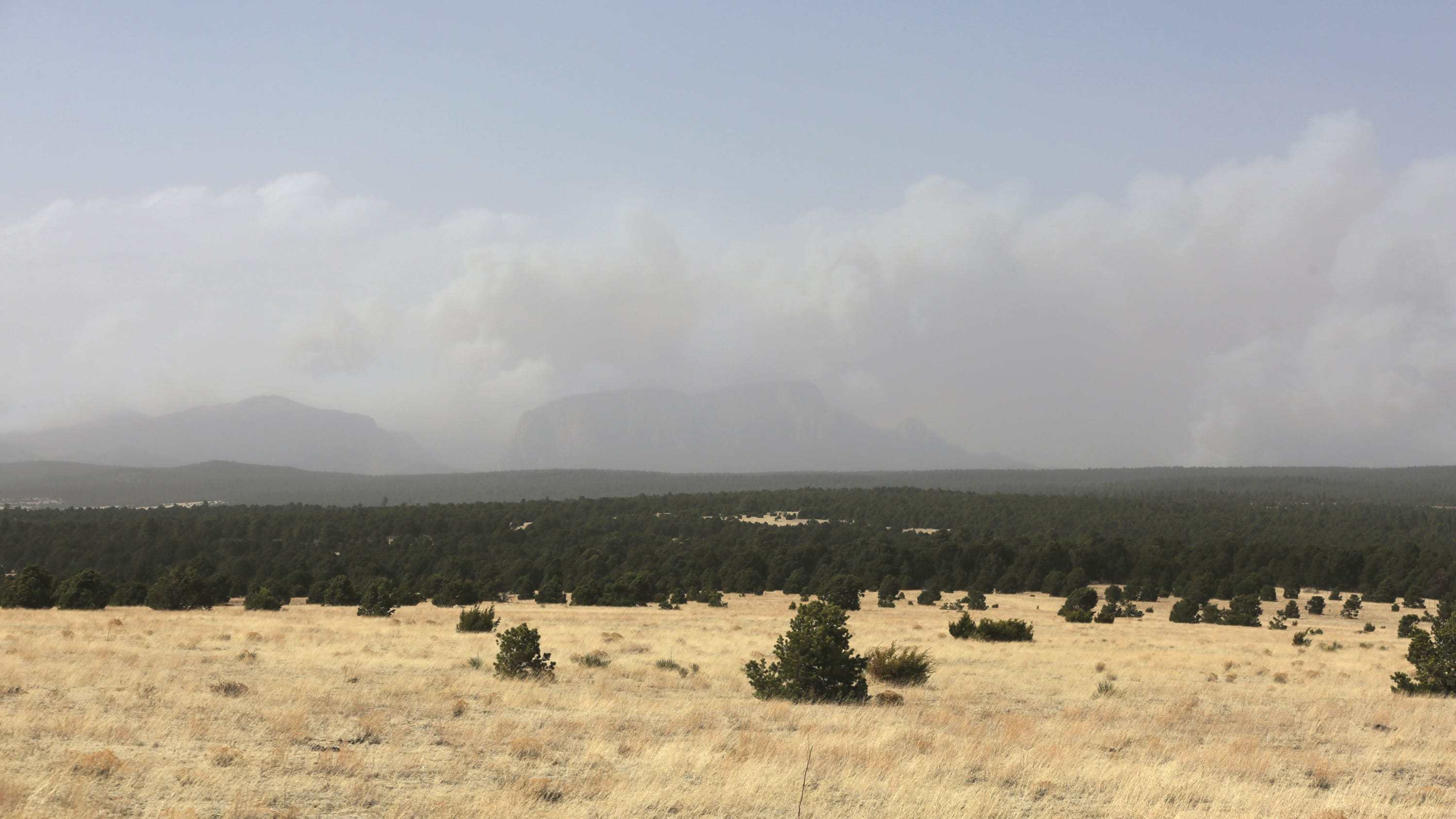 Smoke rises from two wildfires outside of Las Vegas, New Mexico.