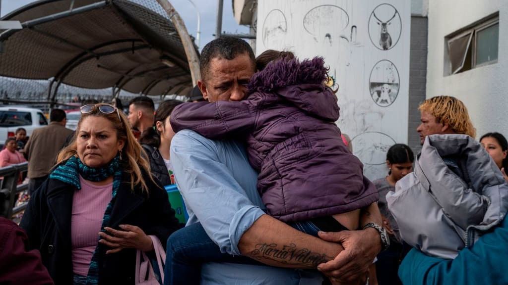 A Venezuelan man holds his daughter at the U.S. southern border.