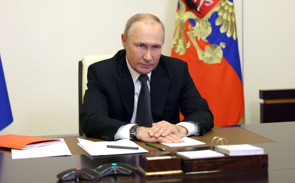 Putin sitting at desk