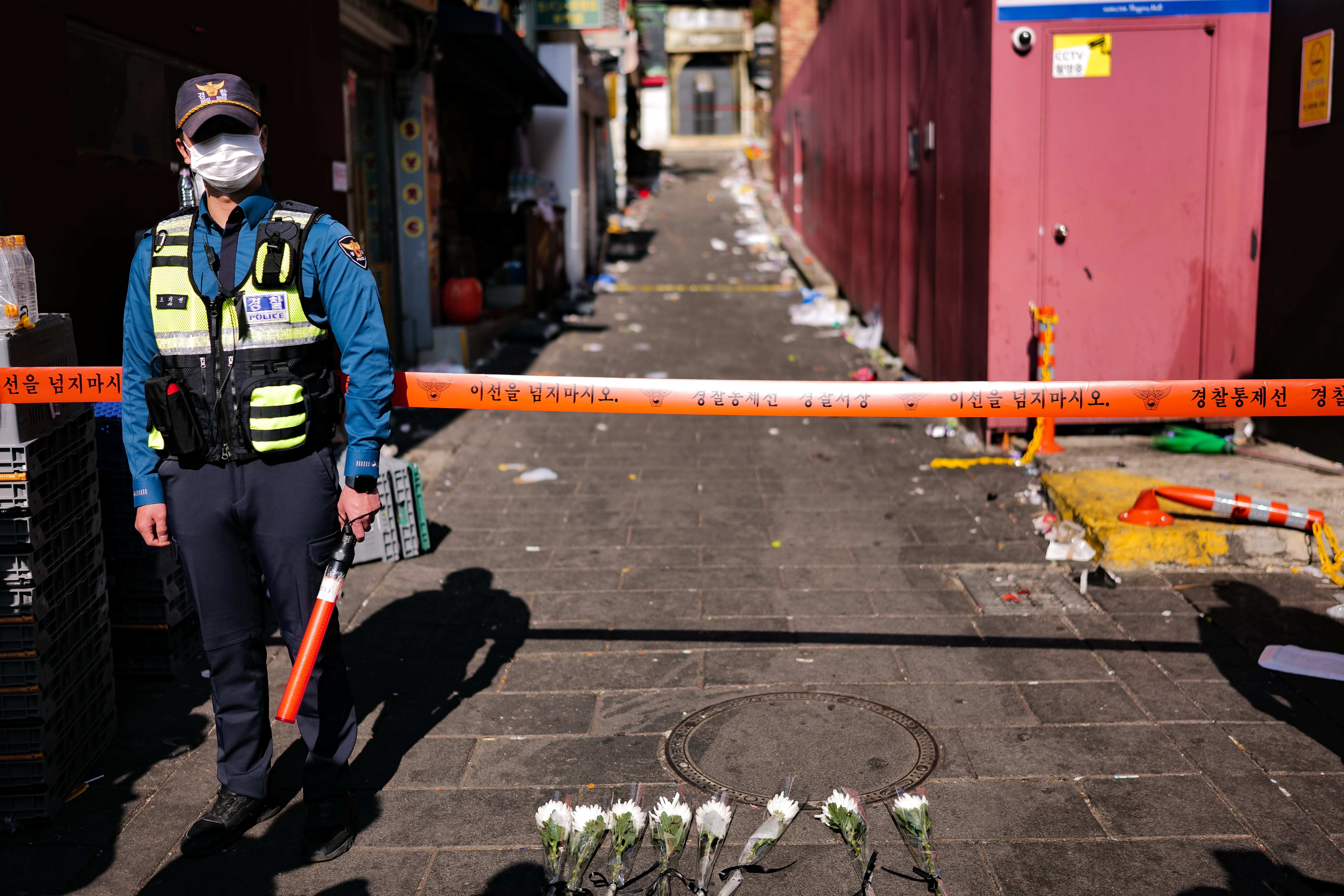 Police block off entry to an alleyway following a deadly crowd crush in Seoul, South Korea. 