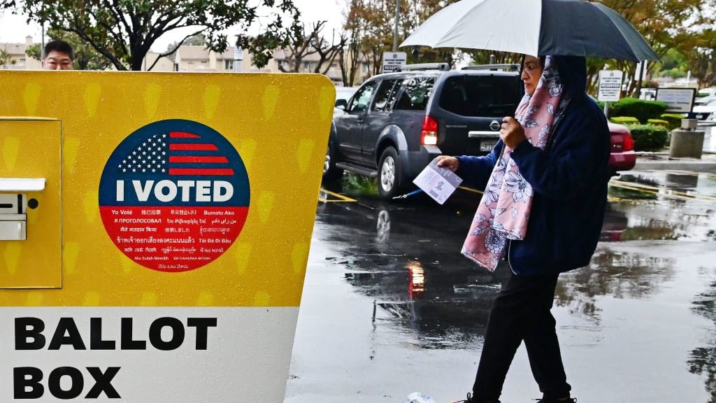A woman drops off her ballot in Norwalk, California.