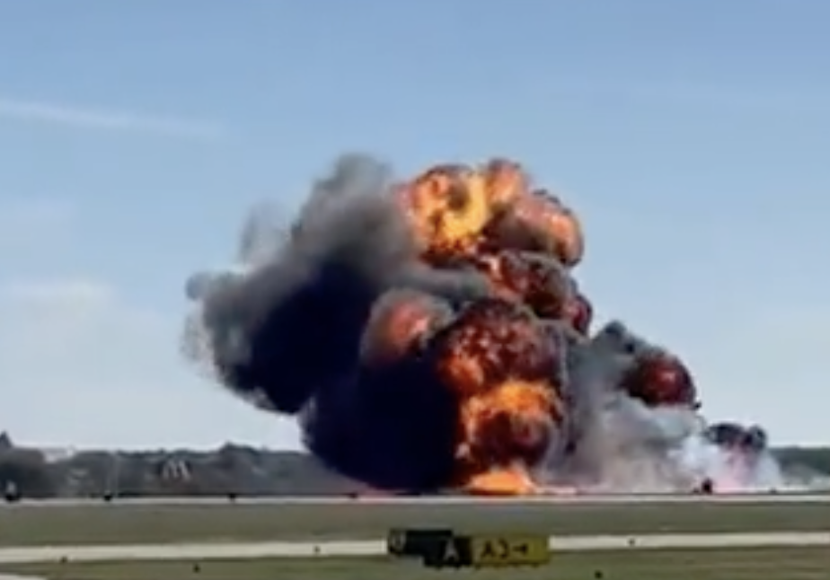 A fireball is seen rising from a plane crash in Dallas during an airshow. 