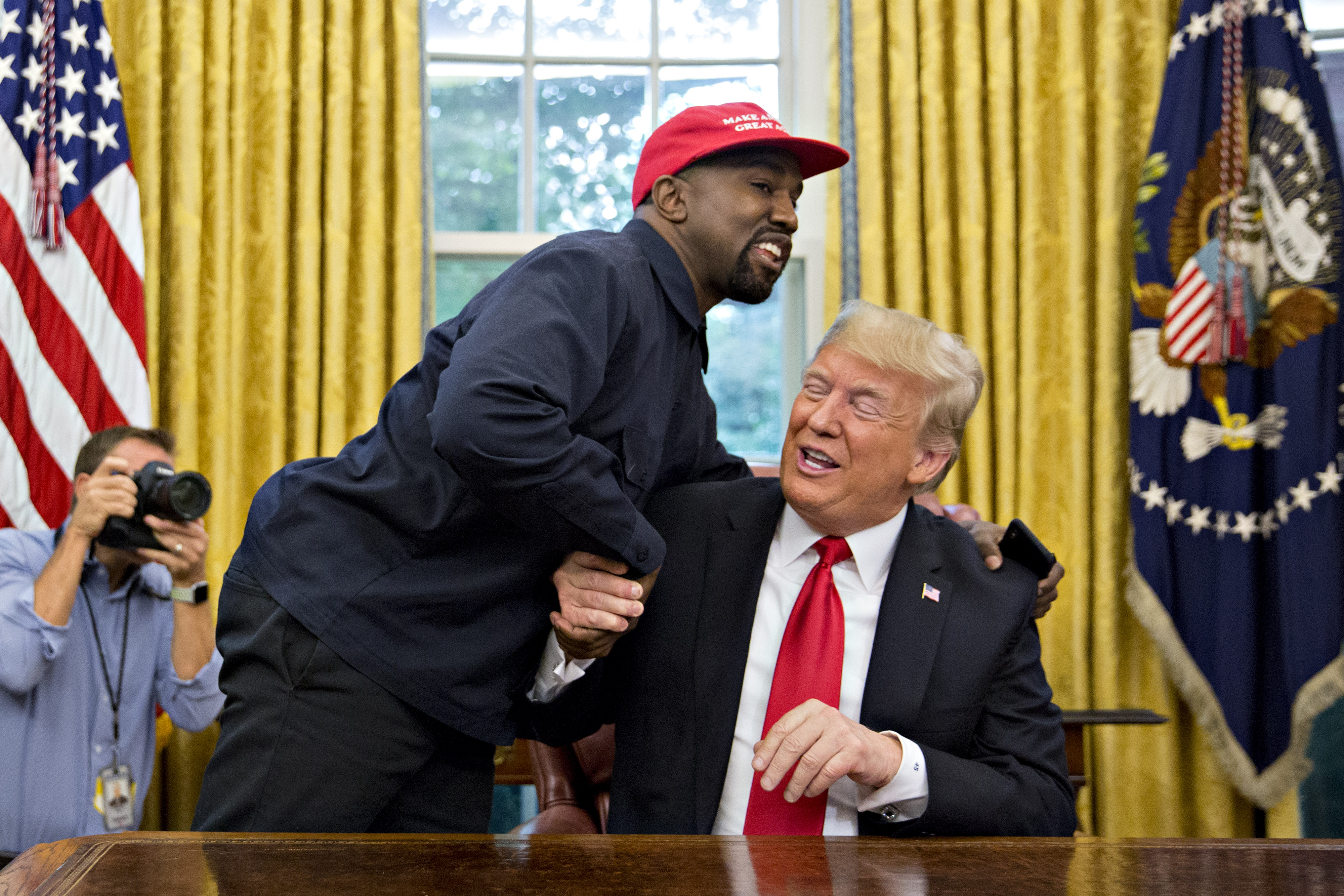 Former President Donald Trump and rapper Ye seen talking. 