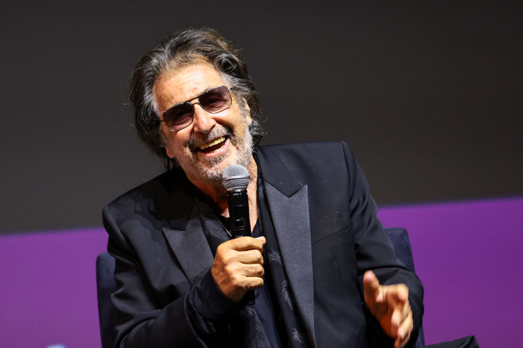 Actor Al Pacino holding a microphone during a festival panel.