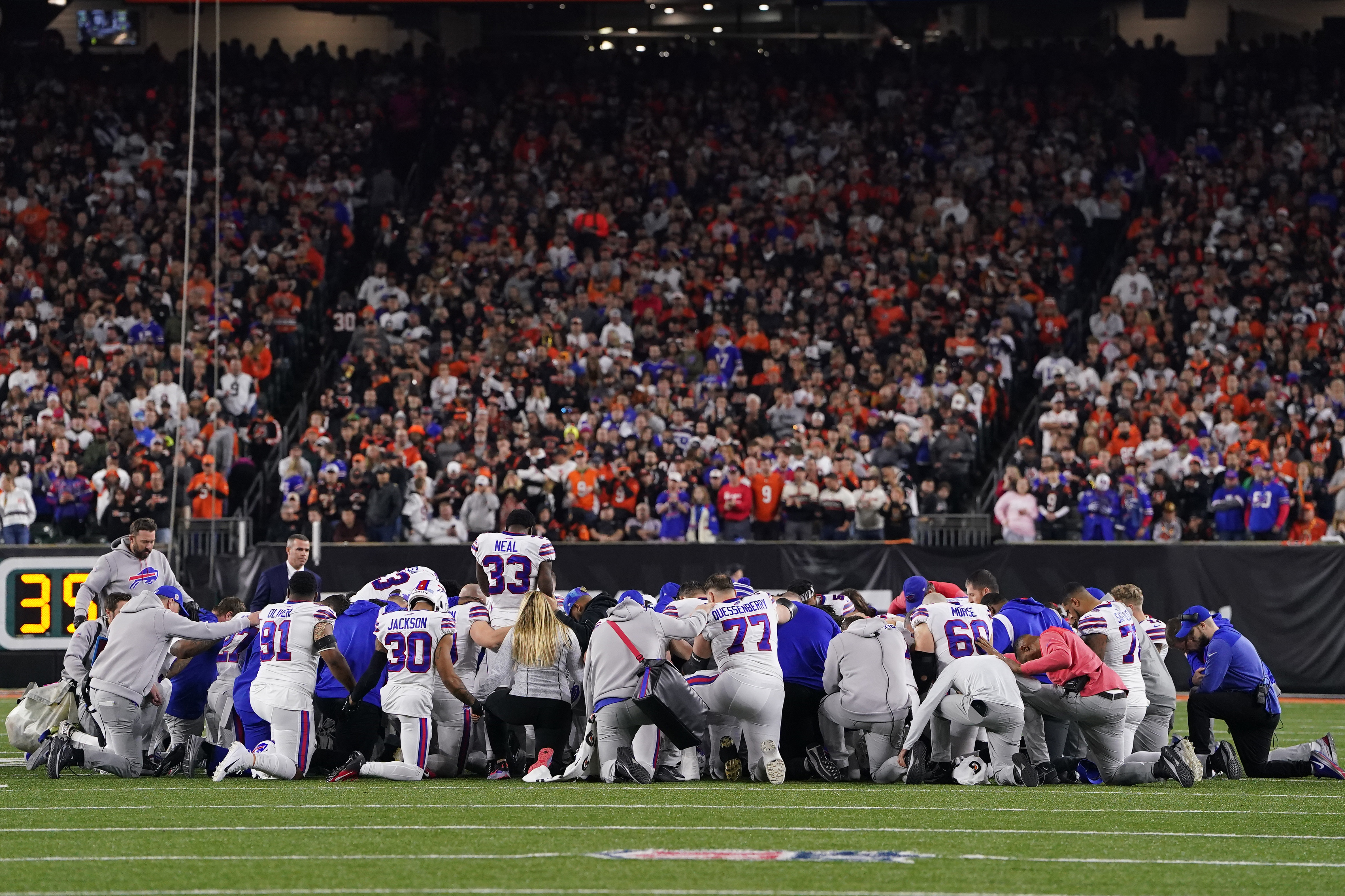 Bills players pray following an injury to teammate Damar Hamlin. 