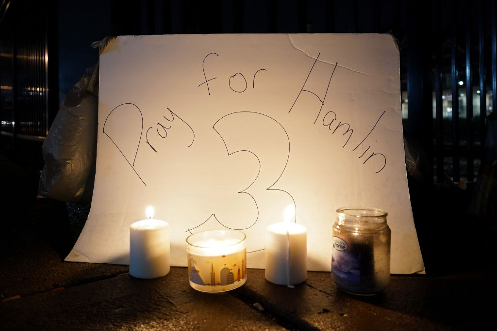 &quot;Pray for Hamlin&quot; sign behind candles.