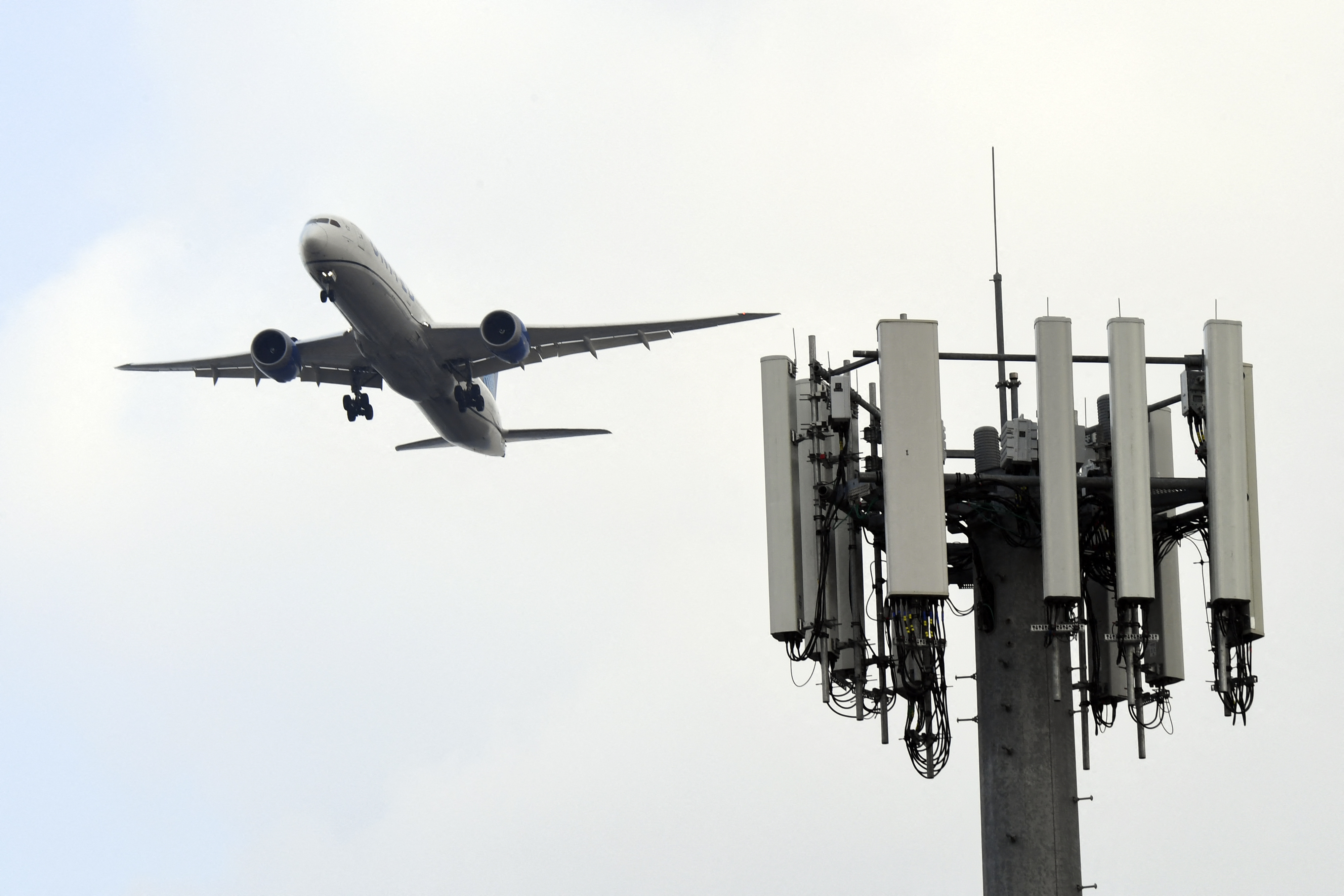A cell tower is seen as a plane lands at Los Angeles International Airport. 