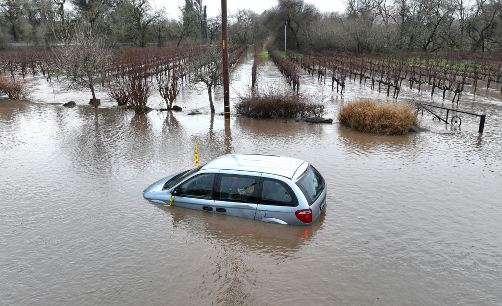 a car is submerged in floodwater.