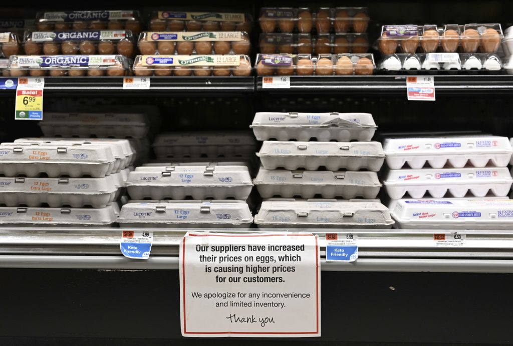 Egg shelves are seen with a note apologizing to customers for the price increase of eggs