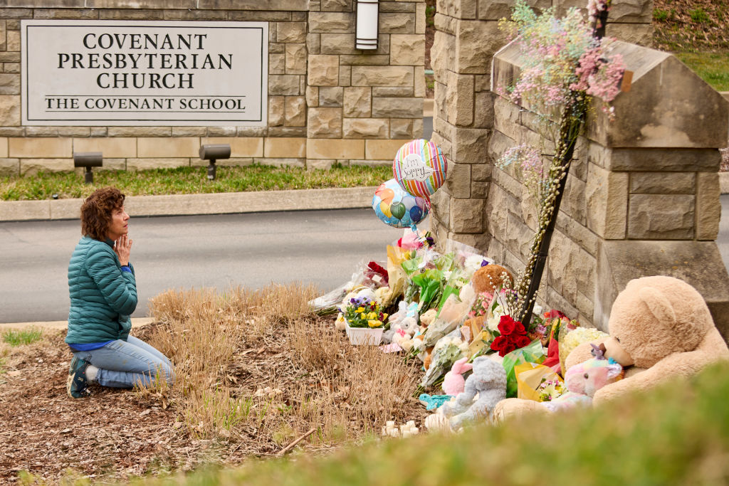 A woman looks up and prays at the Memorial held at The Covenant School after the shooting.