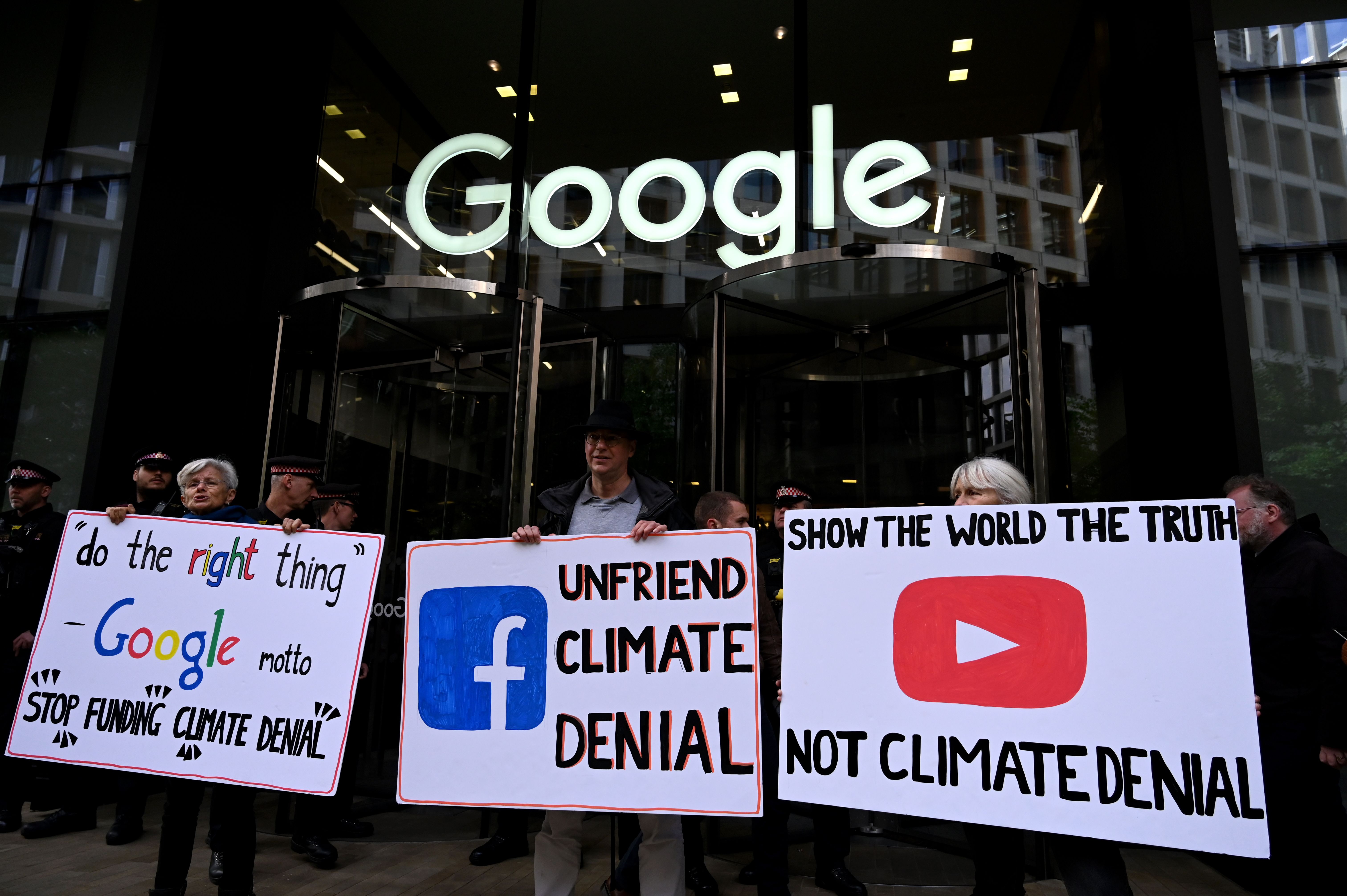 Climate denial signs outside Google building