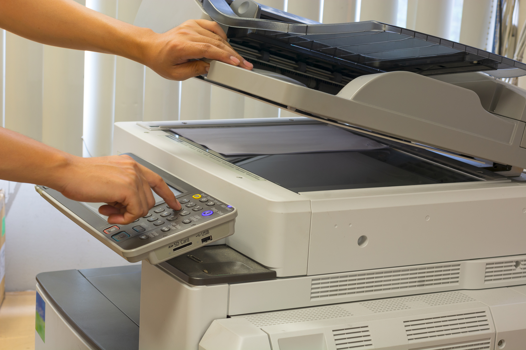 A hand using a fax machine