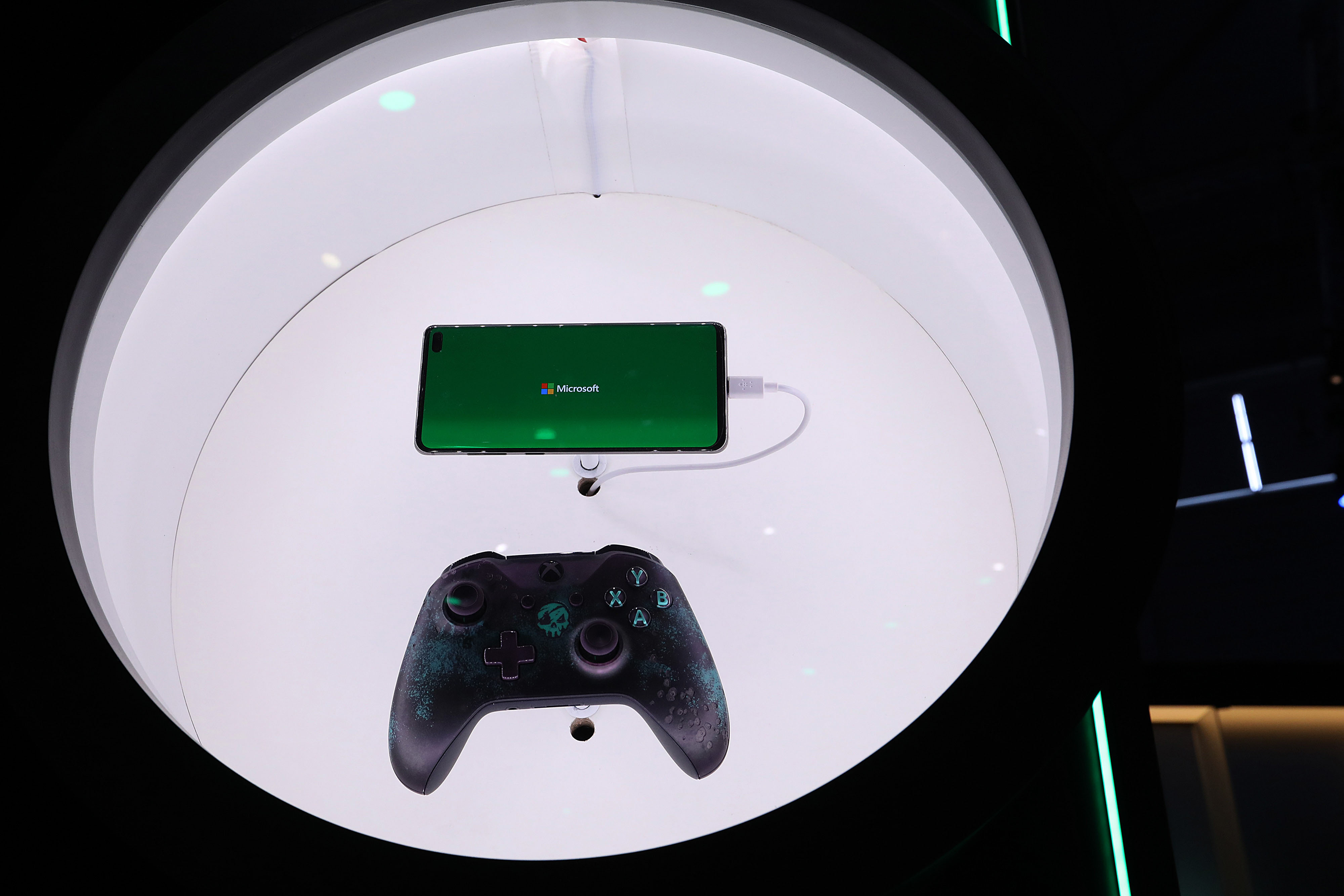 An Xbox games console controller and a smartphone 