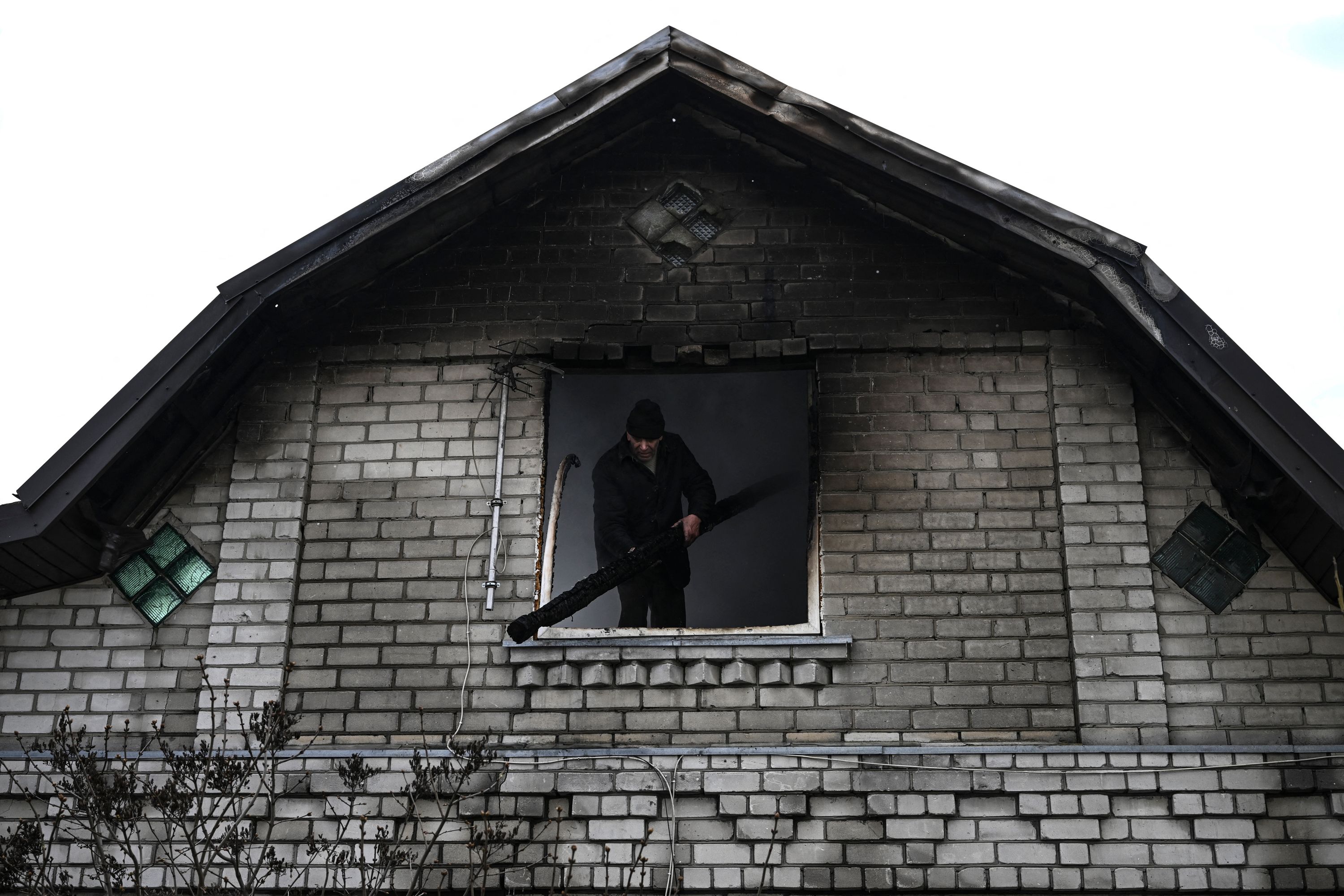 A man inside a shelled house.