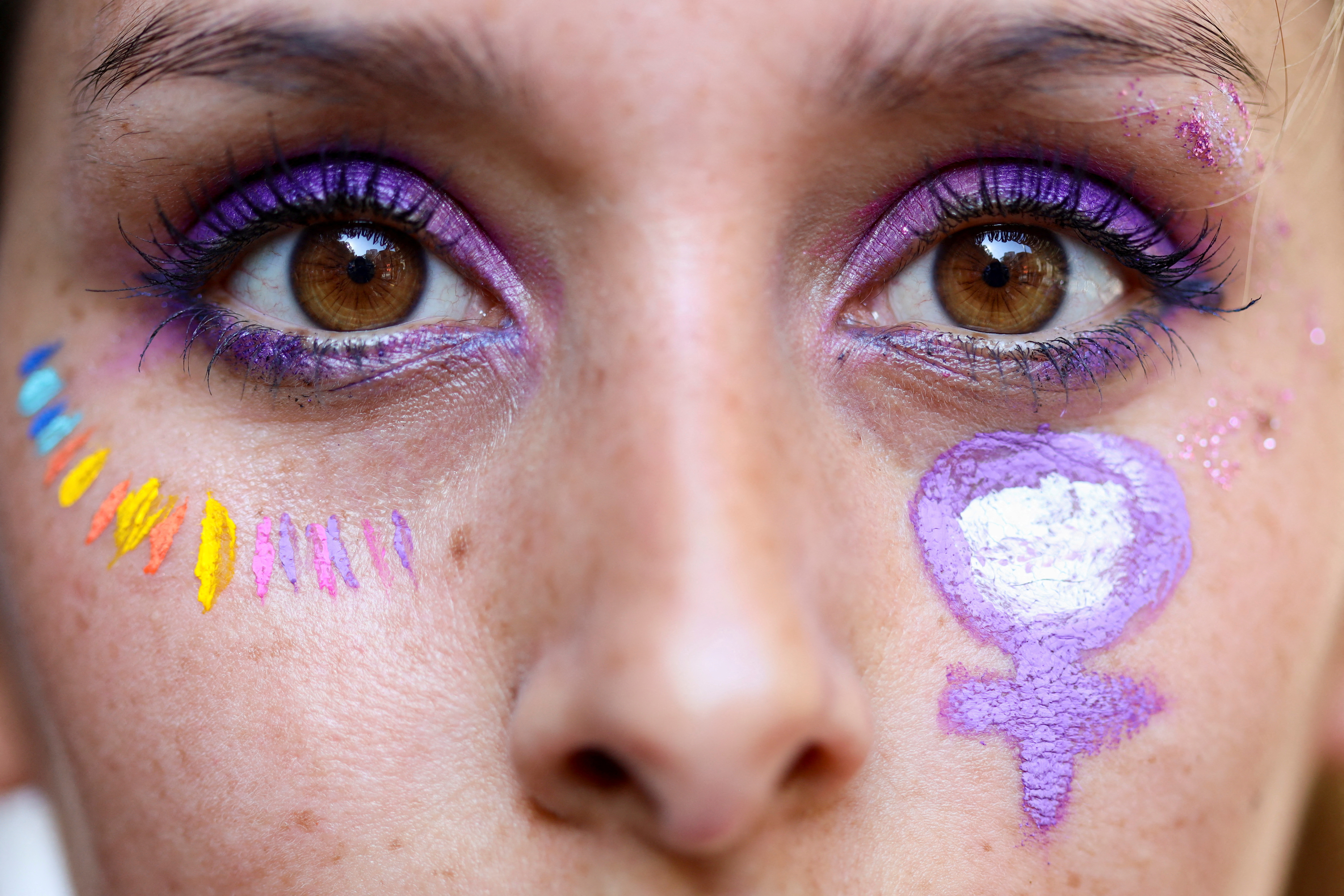 Woman wears face paint.