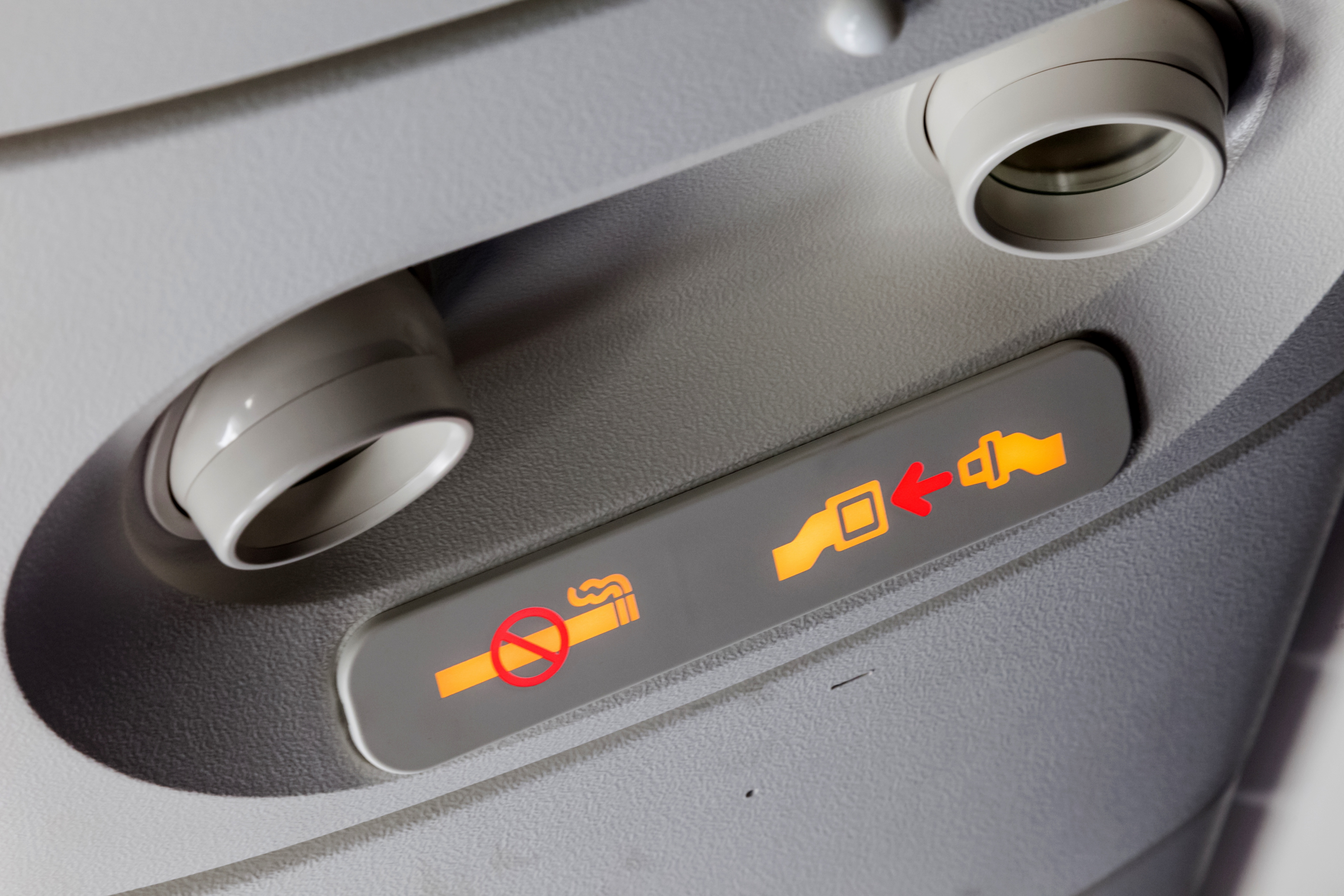 The fasten seatbelt sign on an airplane